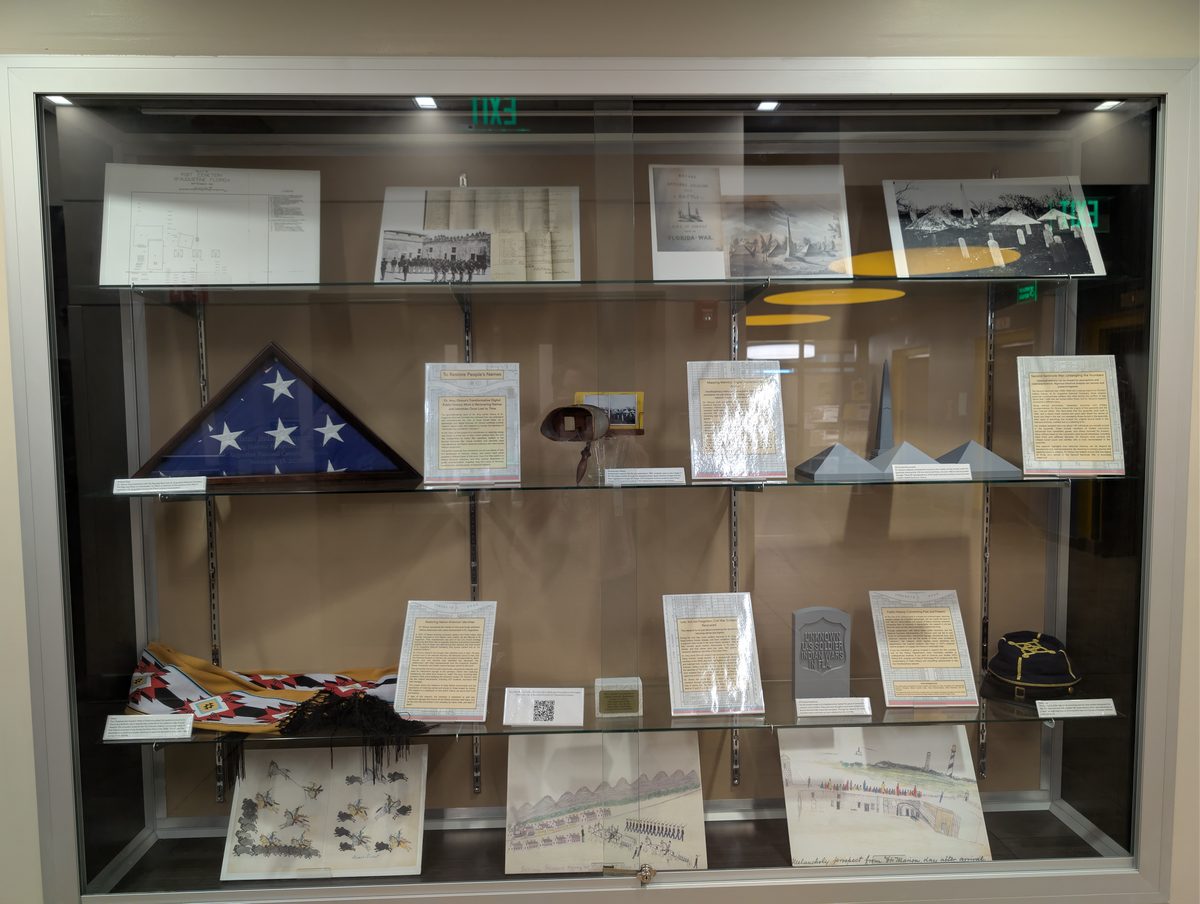 The physical exhibit displayed in a glass case in the hallway, showing the panels created by Dr. Giroux's student team
